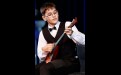 Десятилетний Иван Попов из Усть-Илимска получил новенькую балалайку, он исполнил для гостей композицию Даниила Крамера «Танцующий музыкант»