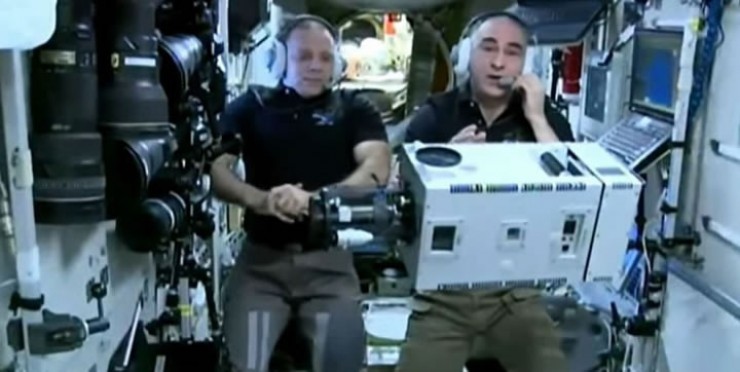 Анатолий Иванишин (справа) показывает устройство, при помощи которого с орбиты делаются снимки земной поверхности. Иркутские школьники в формате видеороликов показали свои домашние задания, а затем задали вопросы космонавтам